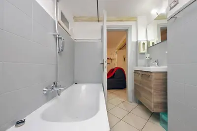 a white bathroom with a tub and a sink at Al moro in Rome