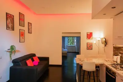 a living room with a black couch and a table at Domus Aura in Rome
