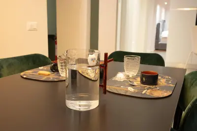 a table with two plates and a glass of water at Gracchi39 Apartment in Rome