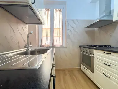 a kitchen with a sink and a stove at Modern apartment with Private Balcony Near Colosseum in Rome