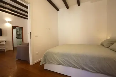 a bedroom with a bed and a chair in it at Serpenti Holiday House in Rome