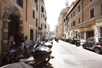 a row of motorcycles parked on the side of a street at Serpenti Holiday House in Rome
