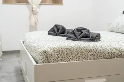 a bed with two towels sitting on top of it at Sallustiano - Porta Pia - Rooms in Rome