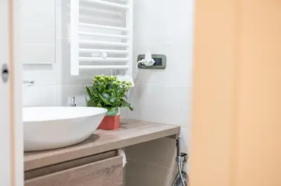 a bathroom with a white sink on a counter at Sallustiano - Porta Pia - Rooms in Rome