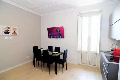 a kitchen and dining room with a table and chairs at San Giovanni Suite Rome in Rome