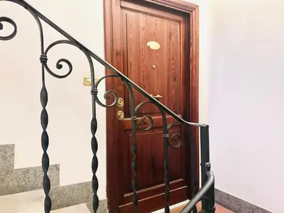 a wooden door on the side of a stairs at San Giovanni Lulus Home in Rome