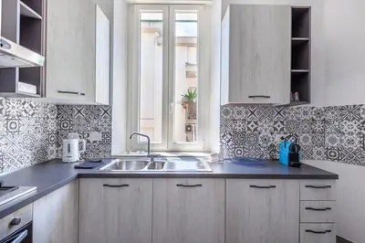 a kitchen with a sink and a window at Ponte Milvio 3 Bedroom Apartment in Rome