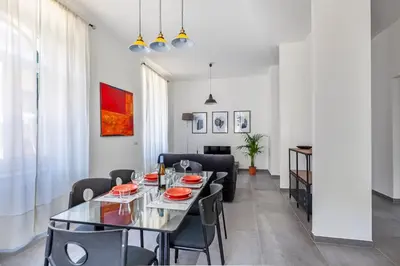 a dining room with a table and chairs at Ponte Milvio 3 Bedroom Apartment in Rome