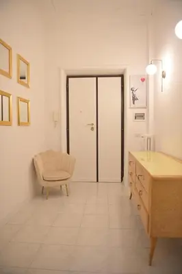 a living room with a chair and a table at Tasso 39 in Rome