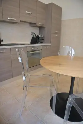a kitchen with a wooden table and two chairs at Tasso 39 in Rome