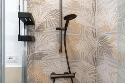 a shower with a shower head on a wall at Ponte Milvio-Olympic Stadium Modern Apartment in Rome