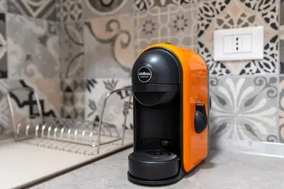 an orange and black coffee maker sitting on a counter at Ponte Milvio-Olympic Stadium Modern Apartment in Rome