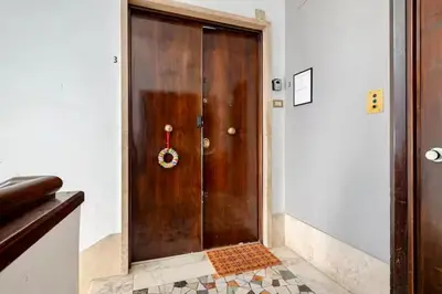 a large wooden door with a wreath on it at Victoira's appartament in Roma in Rome