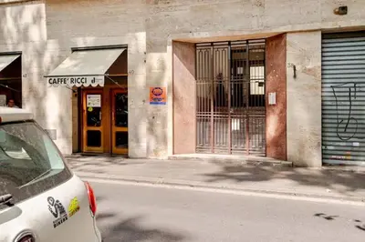 a white car parked in front of a building at Victoira's appartament in Roma in Rome