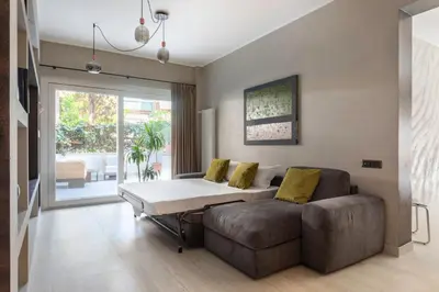 a living room with a couch and a table at Pool & Spa Deluxe in Rome