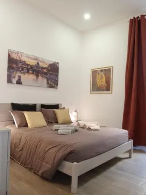 a bedroom with a large bed in a room at Laterano 190 apt at Colosseo in Rome