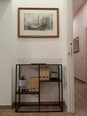 a table in a room with a picture on the wall at Laterano 190 apt at Colosseo in Rome