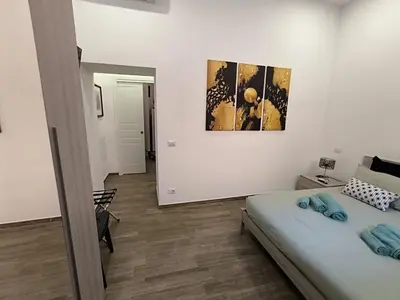 a bedroom with a bed and a mirror at Laterano 190 apt at Colosseo in Rome