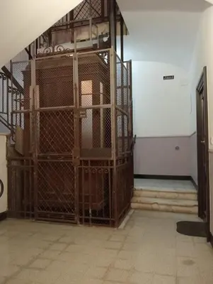 an empty room with a cage in a building at Laterano 190 apt at Colosseo in Rome