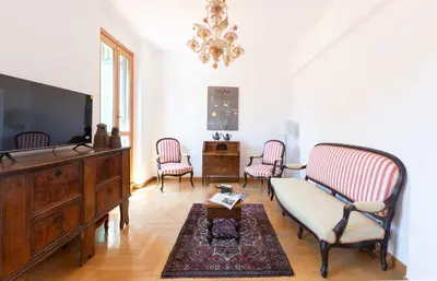 a living room with two chairs and a tv at Casa Arezzo - silenzioso trilocale con terrazzino privato - Cale 06 in Rome