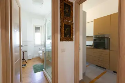 a kitchen with a glass door leading into a room at Casa Arezzo - silenzioso trilocale con terrazzino privato - Cale 06 in Rome