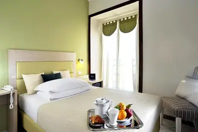 a hotel room with a bed with a tray of food at Hotel Scott House in Rome