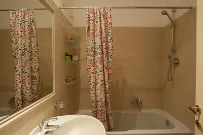 a bathroom with a sink and a tub and a shower at Finestre sul Tevere in Rome