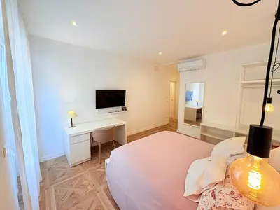 a bedroom with a bed and a desk and a tv at Vacanze Pamphili in Rome