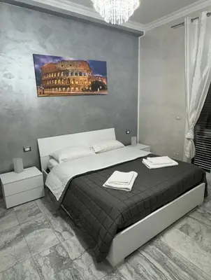 a bedroom with a bed with two towels on it at Cataldo Suites Roma in Rome