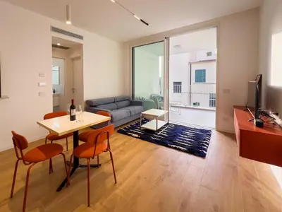 a living room with a table and chairs and a couch at Pop House Labicana in Rome