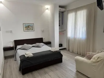 a bedroom with a bed and a couch at La Casetta Monteverde in Rome