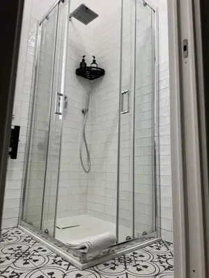a shower with a glass door in a bathroom at La Casetta Monteverde in Rome