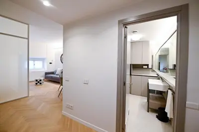 a kitchen and living room with a door leading into a room at Dolce Vita Suite by Rental in Rome in Rome