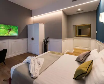 a bedroom with a bed and a tv on the wall at Jb Relais Luxury in Rome