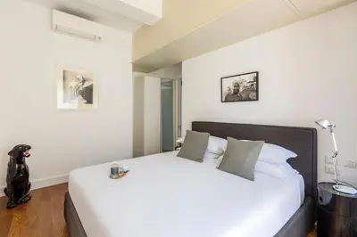 a bedroom with a large white bed in a room at Casa Lea by Hili in Rome
