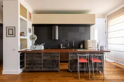 a kitchen with a counter with two stools at Casa Lea by Hili in Rome