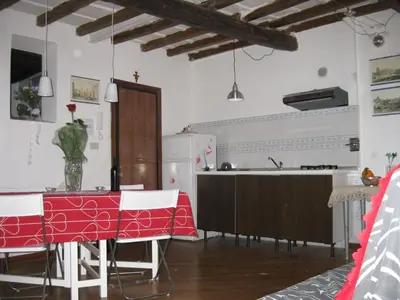 a kitchen with a table with a red table cloth at Musa Apartments in Rome