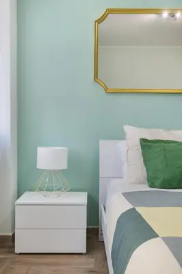 a bedroom with a bed and a lamp on a nightstand at Conca D'Oro Guest House - Elisabetta in Rome