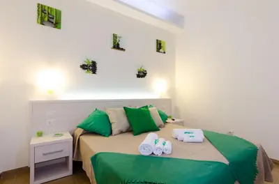 a bedroom with a bed with slippers on it at Gemme Di Roma Accomodation in Rome
