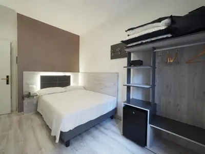 a bedroom with a bed and a book shelf at Casa Di David in Rome