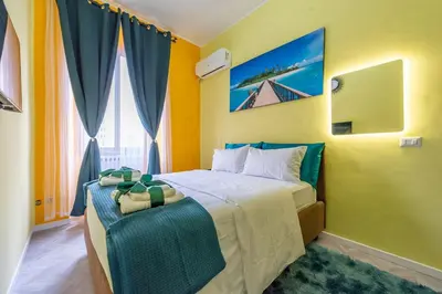 a bedroom with a large bed with yellow walls at Eternal Residency Roman Escape in Rome