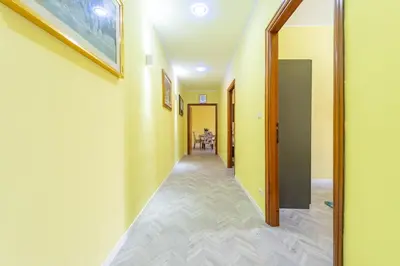 a hallway of a house with yellow walls at Eternal Residency Roman Escape in Rome