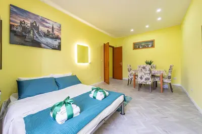 a bedroom with a bed and a dining room at Eternal Residency Roman Escape in Rome
