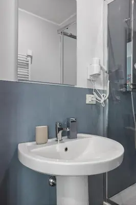 a bathroom with a white sink and a mirror at Conca D'Oro Guest House - Anna in Rome