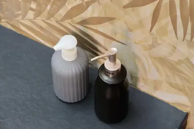 two bottles of liquids sitting next to each other at Trastevere 70 in Rome