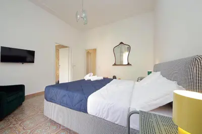 a bedroom with a bed and a flat screen tv at Trastevere 70 in Rome