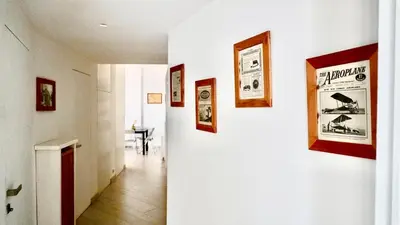 a hallway with pictures on the walls of a house at Entire Flat at Last floor in Piazza Bologna in Rome
