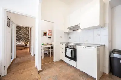 a kitchen with white appliances and a dining room at Feel at Home I Modern Cozy Apartment in Rome