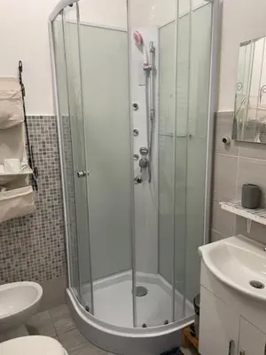 a bathroom with a shower and a toilet and a sink at the room in the museum in Rome