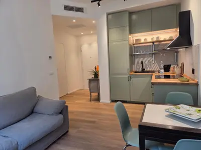a living room with a couch and a kitchen at Maison Viola in Rome